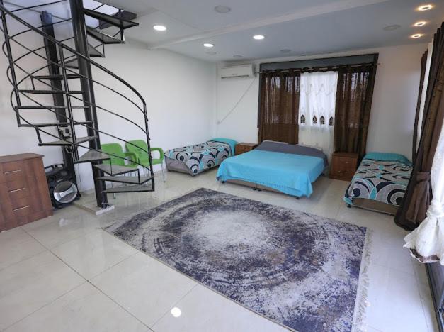 a room with two beds and a spiral staircase at Jericho Palestine, Panorama Villa- View, Full Privacy & Pool in Jericho