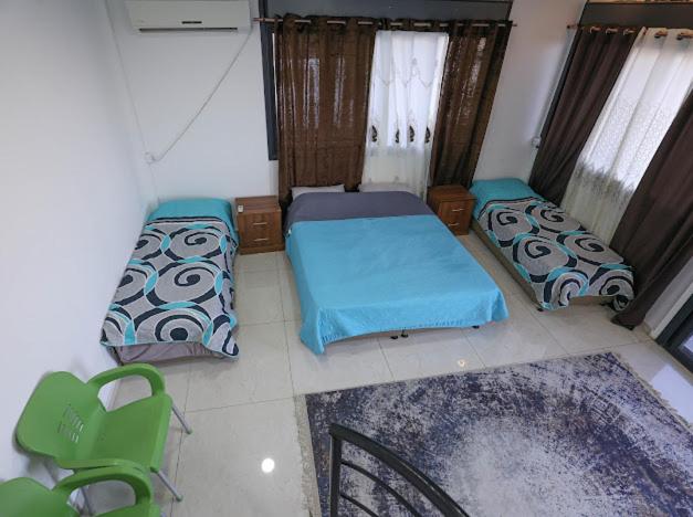 a room with two beds and two chairs in it at Jericho Palestine, Panorama Villa- View, Full Privacy & Pool in Jericho
