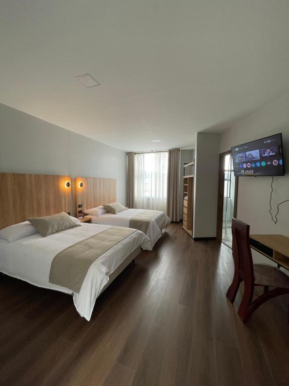 Postel nebo postele na pokoji v ubytování Universitario Hotel