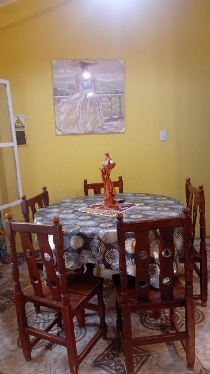 a table in a room with a picture on the wall at Brisa del Cielo in Salta