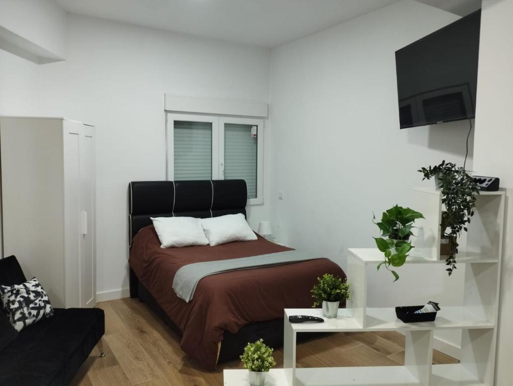Postel nebo postele na pokoji v ubytování Apartamento tipo Loft HM Vista Alegre Madrid