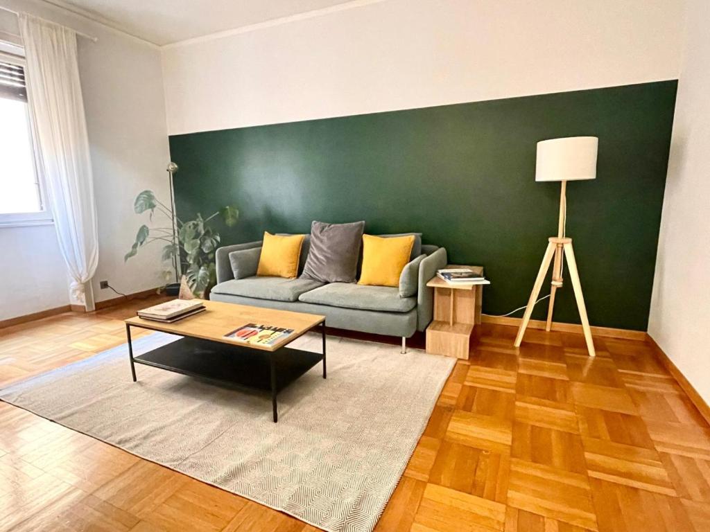 a living room with a couch and a table at Downtown Milan Chic Apartment - Quiet Retreat with Free WIFI & Air Conditioning in Milan