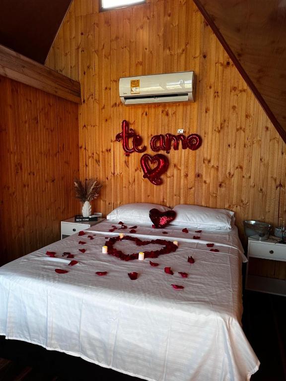 a bedroom with a bed with red roses on it at Playa Aescondidas in Ríohacha