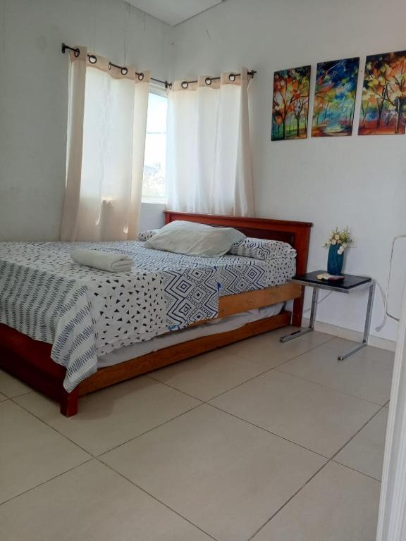 a bedroom with a bed with a table and a window at mirador 1 in Santa Marta