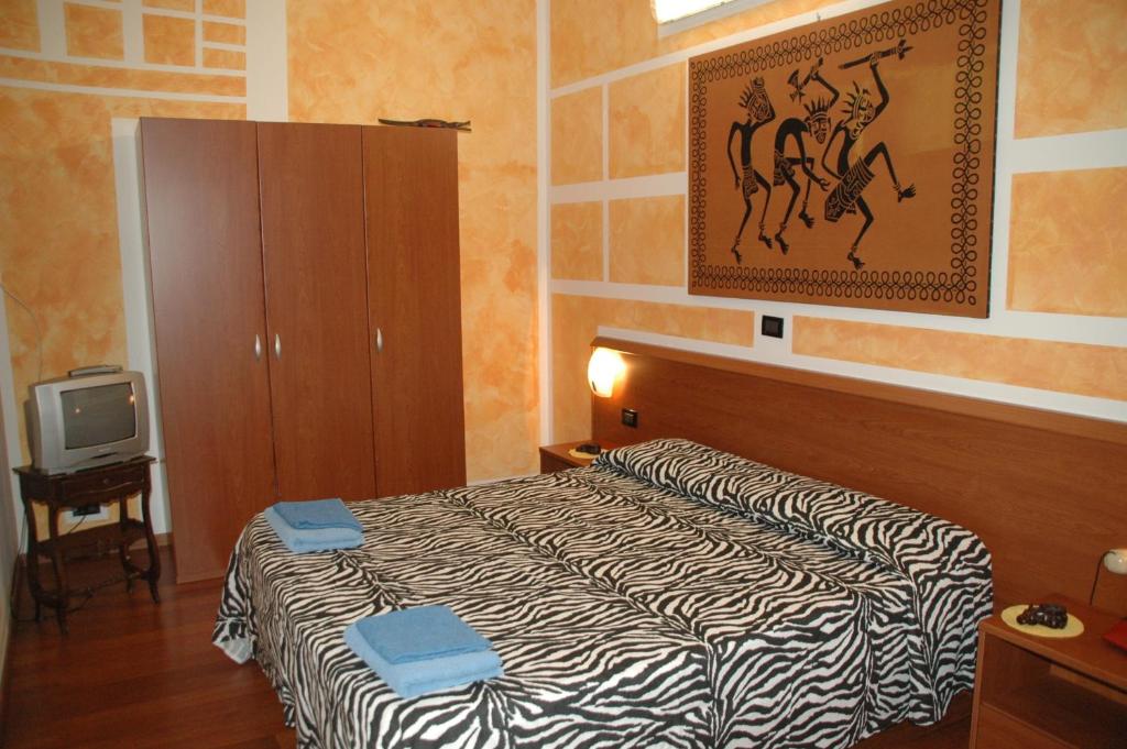 Postel nebo postele na pokoji v ubytování Albergo Astro