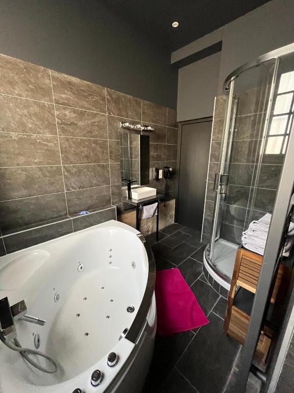 une grande salle de bain avec baignoire et douche dans l'établissement Jardin Abbatiale, à Rouen