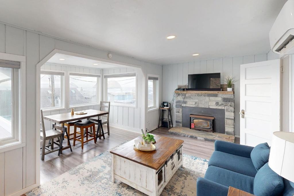 a living room with a blue couch and a fireplace at Oceanside Beach Bungalow in Oceanside