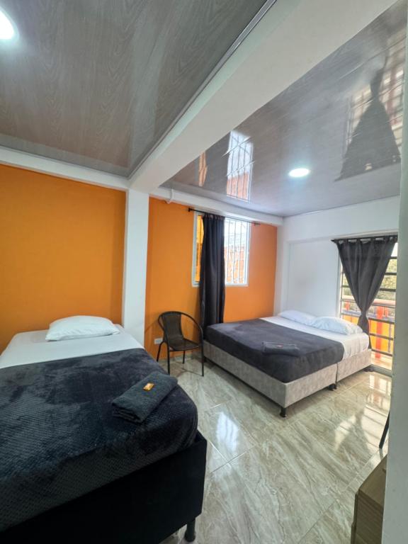 Postel nebo postele na pokoji v ubytování El guadual apartahotel