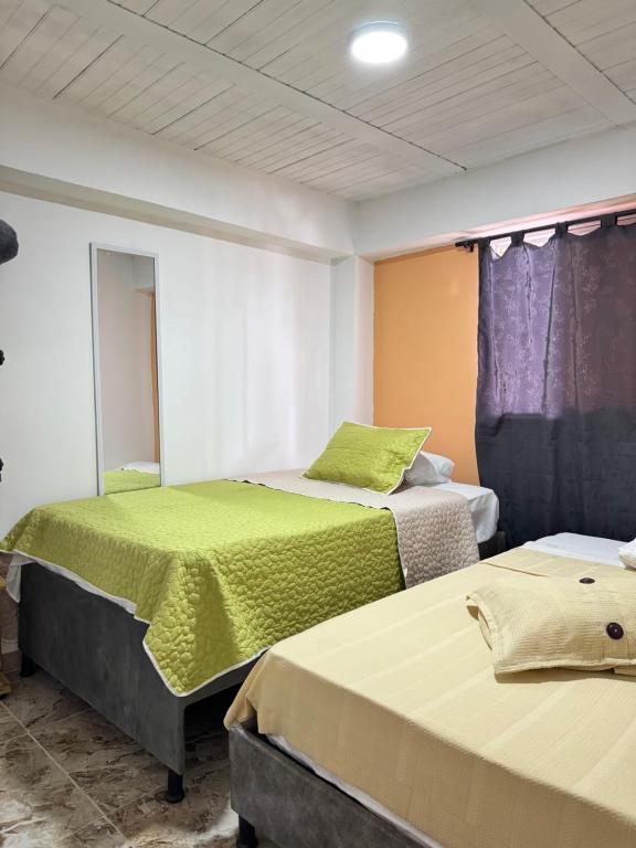 Postel nebo postele na pokoji v ubytování El guadual apartahotel