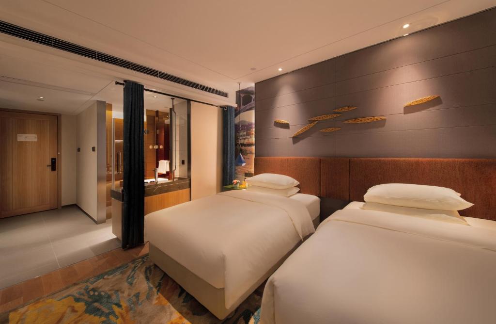 Postel nebo postele na pokoji v ubytování Manju Hotel Zhuzhou Tianyuan District Midea City Times Square