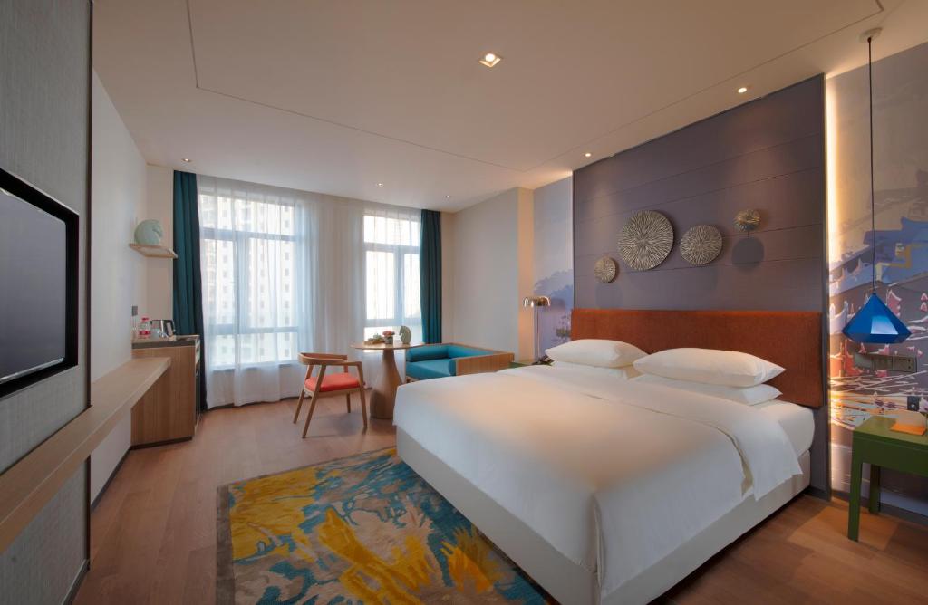 Postel nebo postele na pokoji v ubytování Manju Hotel Zhuzhou Tianyuan District Midea City Times Square