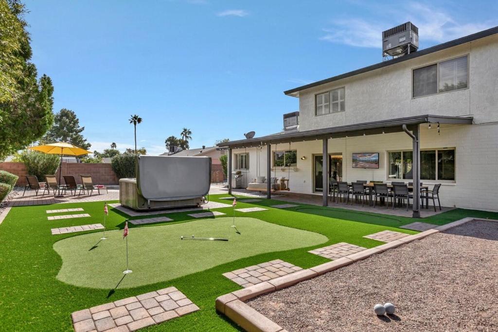 a yard with a tv and golf balls on the grass at 49th St in Phoenix