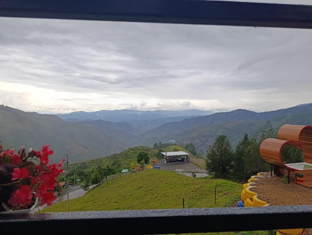 a view of a mountain view from a bench at Glamping Arcoiris in Ciudad Bolívar