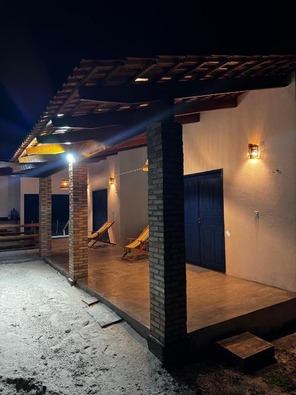 a room with a wooden floor in a building at night at Casa Woody in Santo Amaro