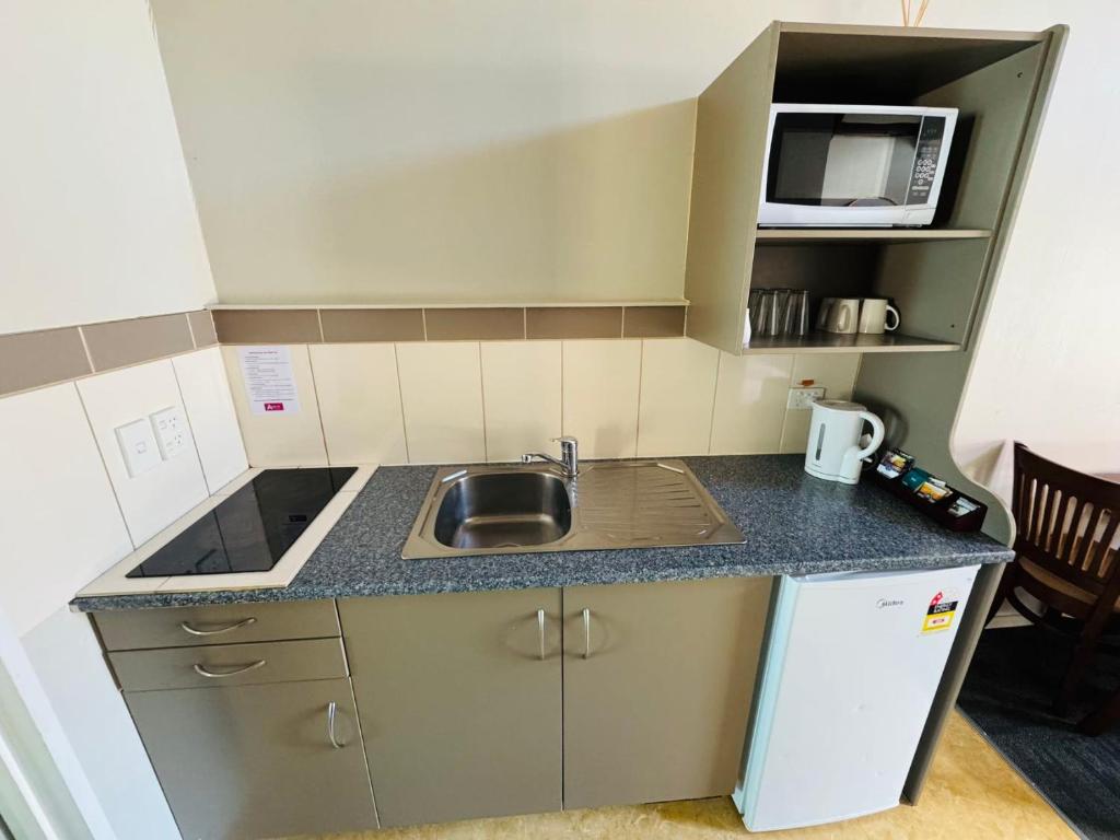 Kuchyň nebo kuchyňský kout v ubytování Apex On Fenton Motel