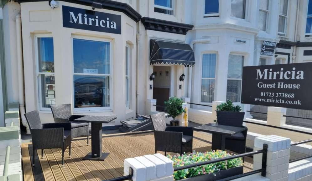 a rendering of a cafe with tables and chairs at Miricia Guest House in Scarborough