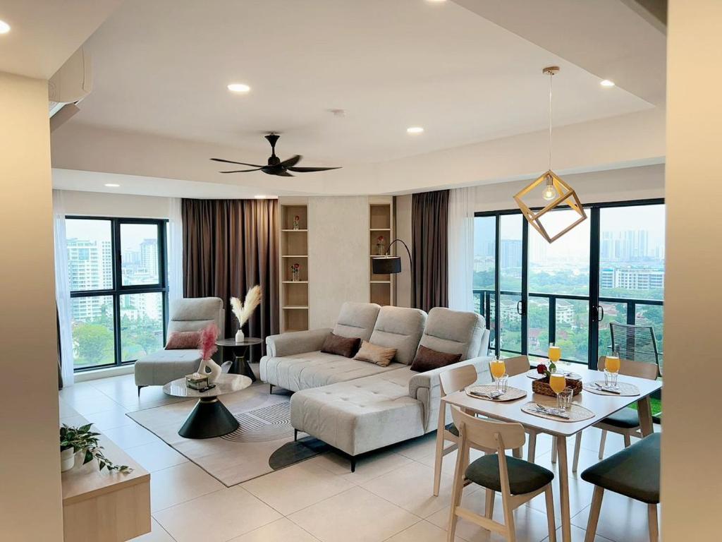 a living room with a couch and a table at The Atrium at Jalan Ampang by OKBnB - Luxury 3 Bedroom Family Suite with Balcony, 3 mins to KLCC in Kuala Lumpur
