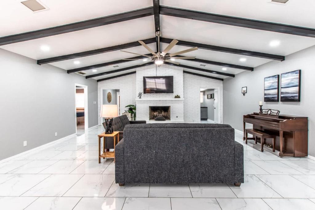 a living room with a couch and a piano at Contemporary Coastal Oasis Awaits in Corpus Christi