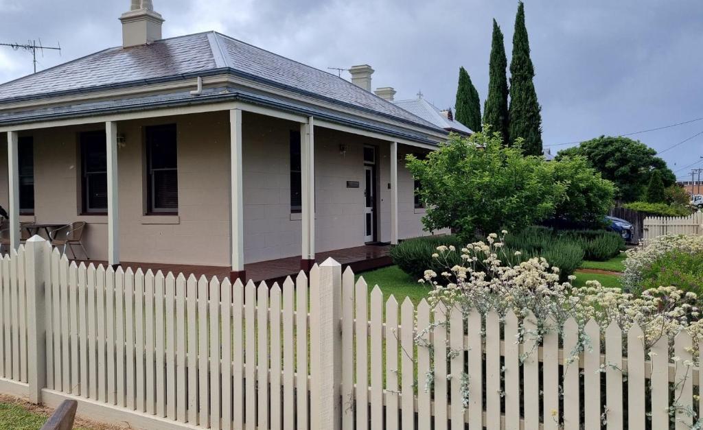a white picket fence in front of a house at The Manse in Queenscliff