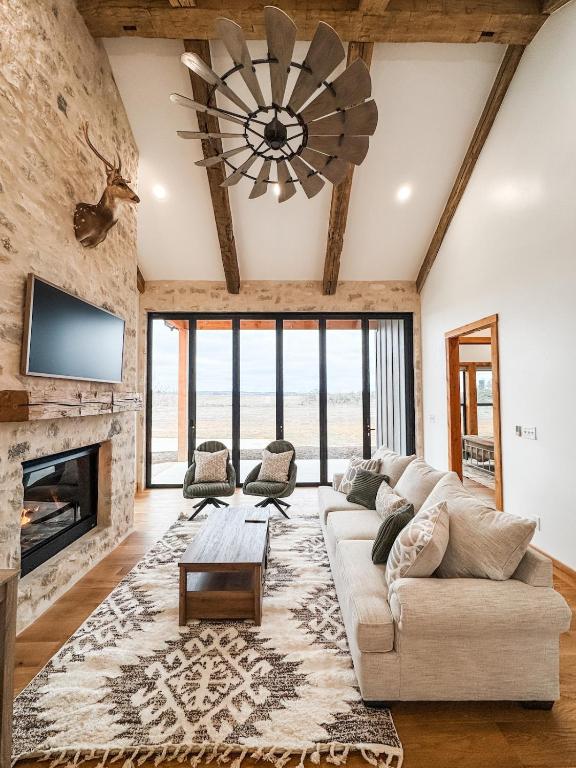 a living room with a couch and a fireplace at Sunday House at The Sanctuary in Fredericksburg