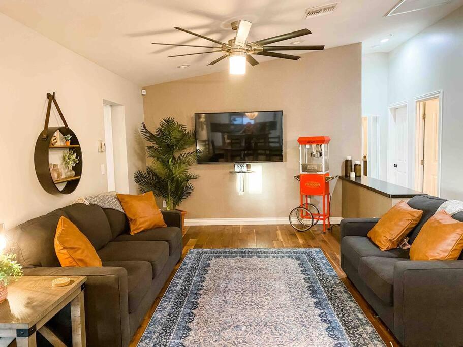 a living room with a couch and a ceiling fan at Scottsdale Farmhouse in Scottsdale