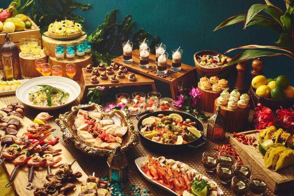 a buffet with many different types of food on a table at ANA InterContinental Manza Beach Resort by IHG in Onna