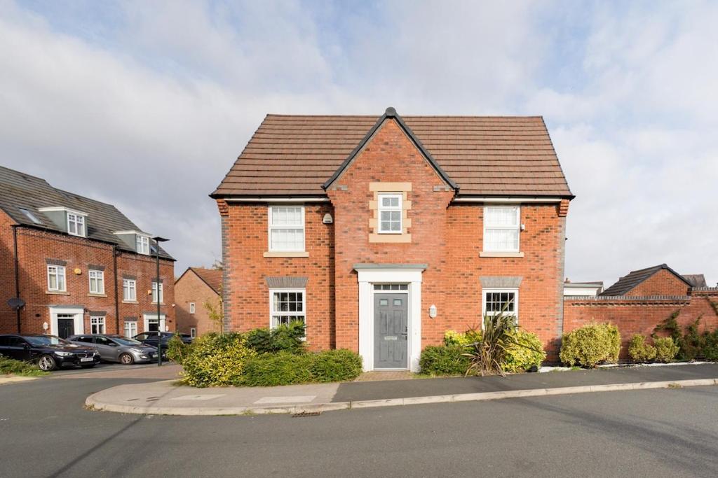 a brick house with a white door on a street at Home away from Home French luxury in Birmingham in Birmingham