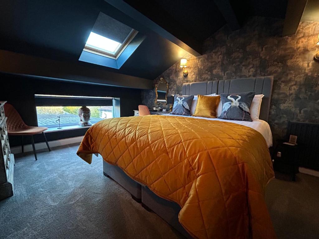 a bedroom with a large bed and a window at Aiskew Villa Annex in Bedale