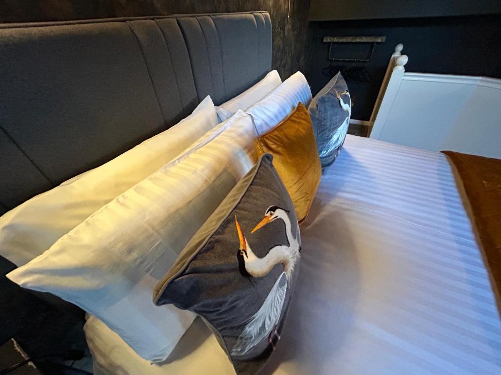 a bed with pillows with a swan on it at Aiskew Villa Annex in Bedale