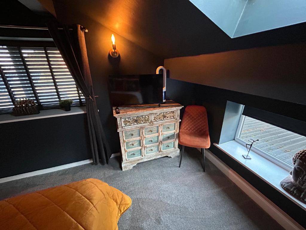a bedroom with a bed and a desk and a chair at Aiskew Villa Annex in Bedale