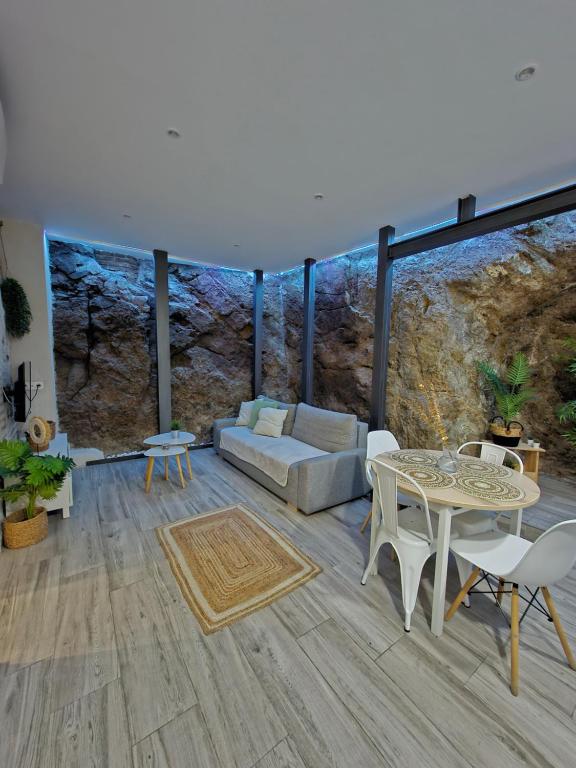 a living room with a couch and a table at El susurro del tajo La gruta in Toledo