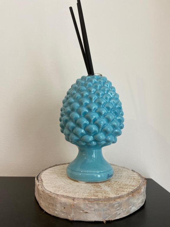 a blue vase filled with balls on a table at Bari Lory’s Home in Bari