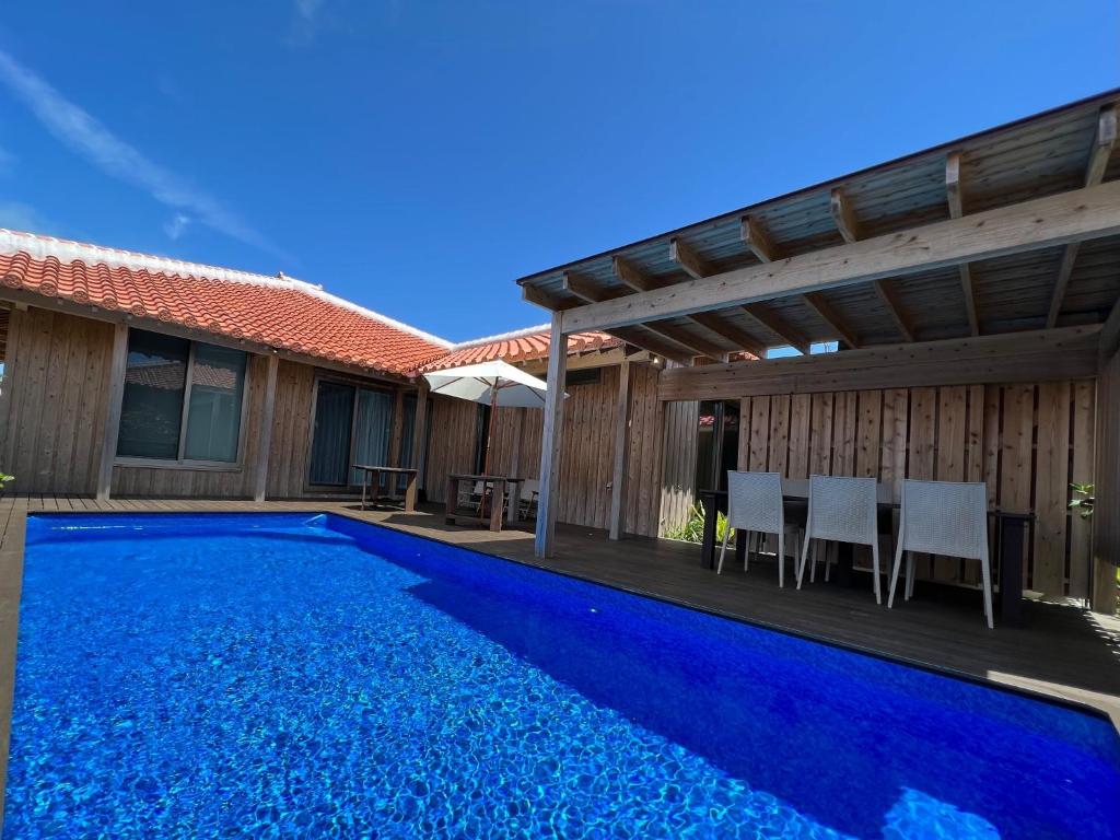 a swimming pool with a pergola next to a house at Villa Muse Okinawa- Vacation STAY 43816v in Nago
