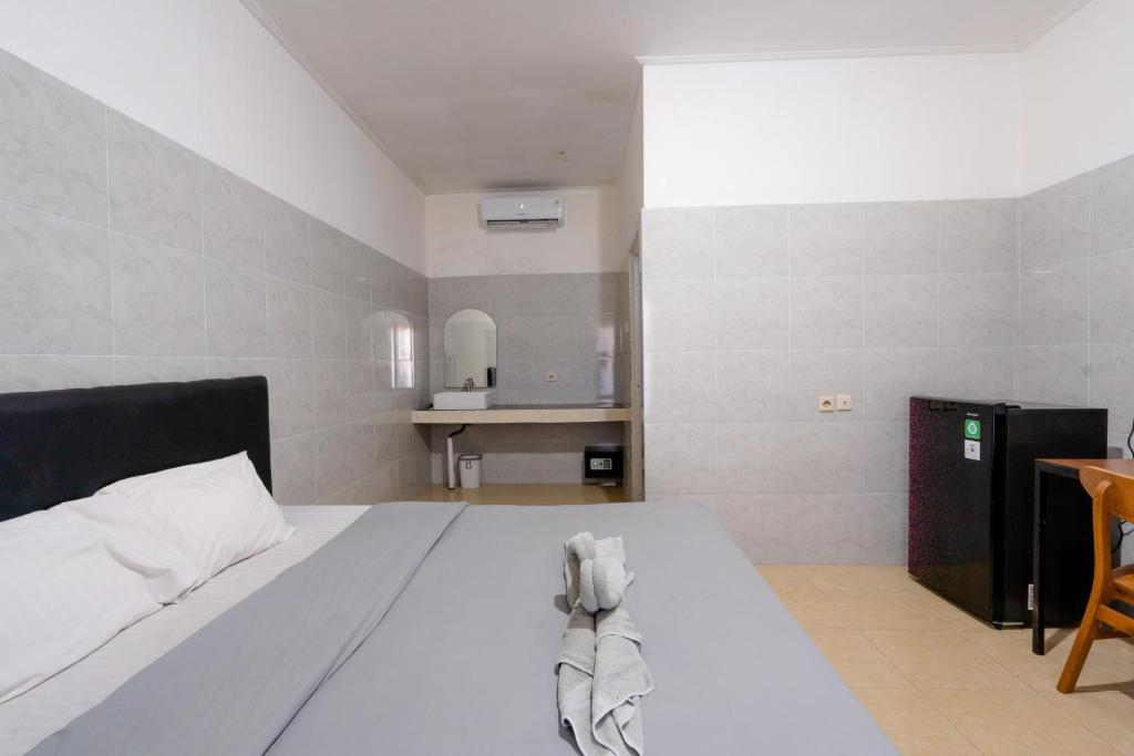 Postel nebo postele na pokoji v ubytování Urbanview Ava Guest House Goa Gong