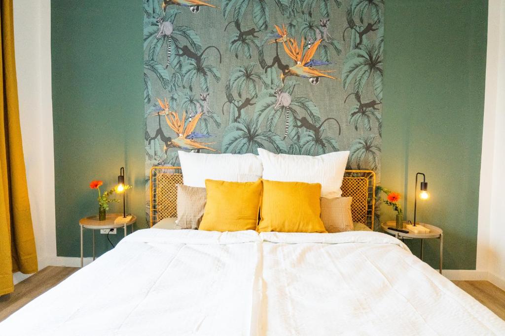 a bedroom with a large bed with yellow pillows at BetterBeds Recklinghausen - Herten in Herten