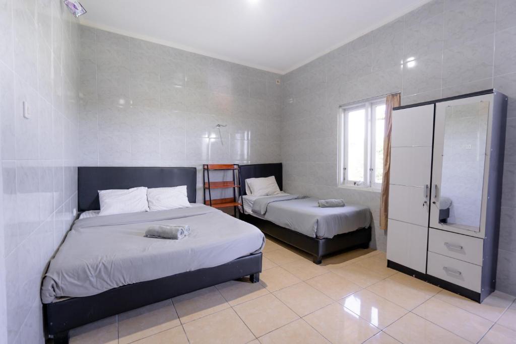 Postel nebo postele na pokoji v ubytování Urbanview Ava Guest House Goa Gong
