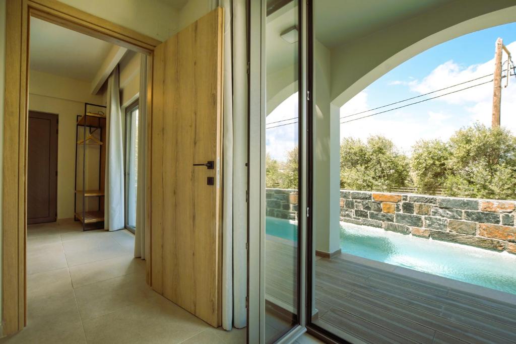 an internal corridor of a house with a pool at Malena Hotel & Suites - Adults Only by Omilos Hotels in Amoudara Herakliou