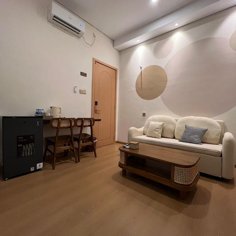 a living room with a white couch and a table at Casabella 106 BCS A2 Grand Batam Penuin Wet Market in Nagoya