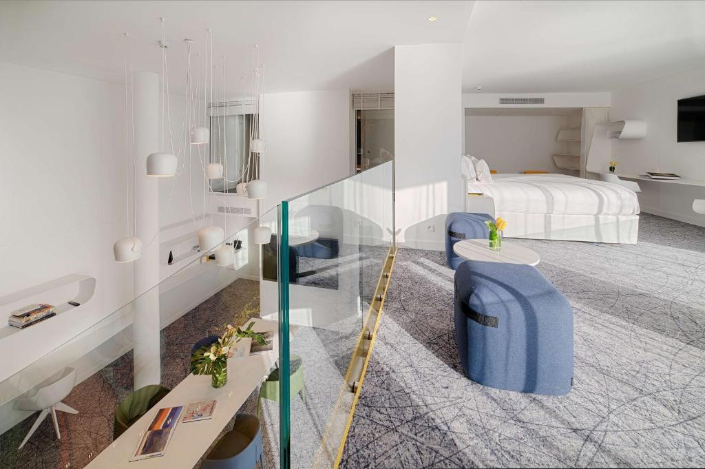 a hotel room with a bed and a glass staircase at nhow Marseille in Marseille