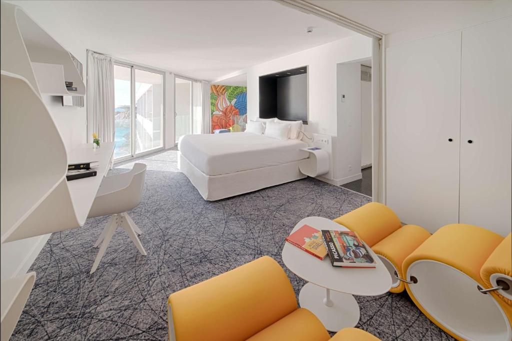 a hotel room with a bed and a couch at nhow Marseille in Marseille