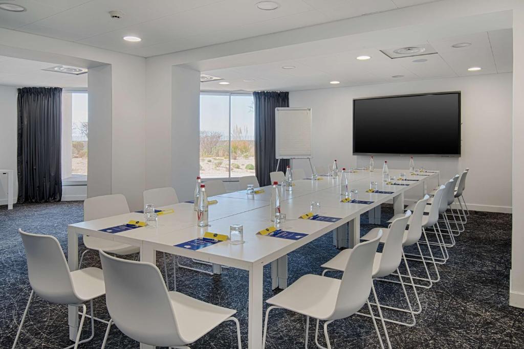 a large conference room with a long table and chairs at nhow Marseille in Marseille