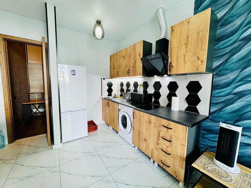 a kitchen with a washer and a washing machine at Квартира у Моря in Batumi