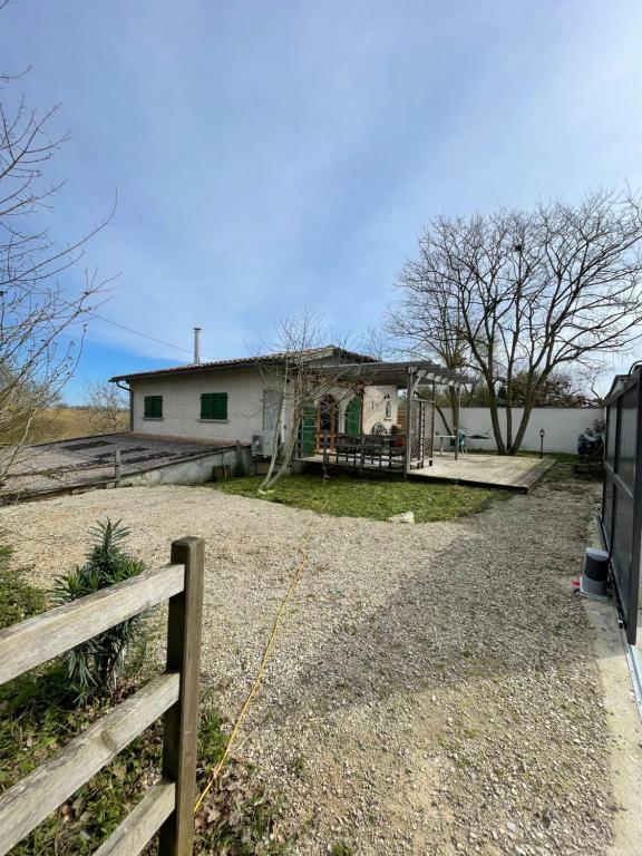 a house with a fence in front of it at Charming house with garden terrace and barbecue in Saint-Cricq