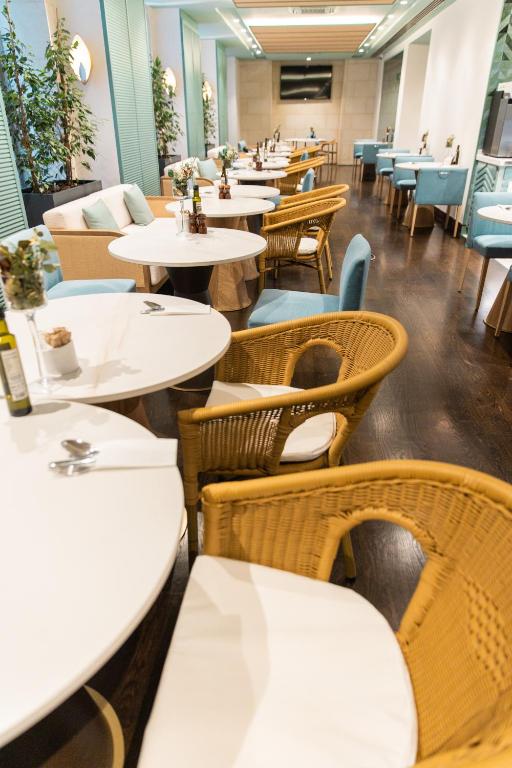 a dining room with tables and chairs and tablesktop at Hospes Amérigo, Alicante, a Member of Design Hotels in Alicante