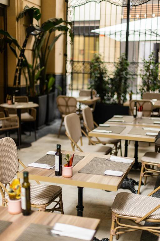 a row of tables and chairs in a restaurant at Hospes Amérigo, Alicante, a Member of Design Hotels in Alicante