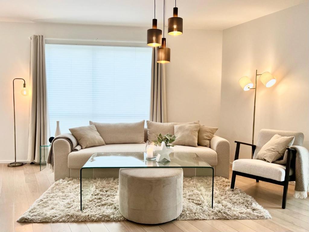 a living room with a couch and a coffee table at Stylish & Central by the pier Cozy balcony in Arendal