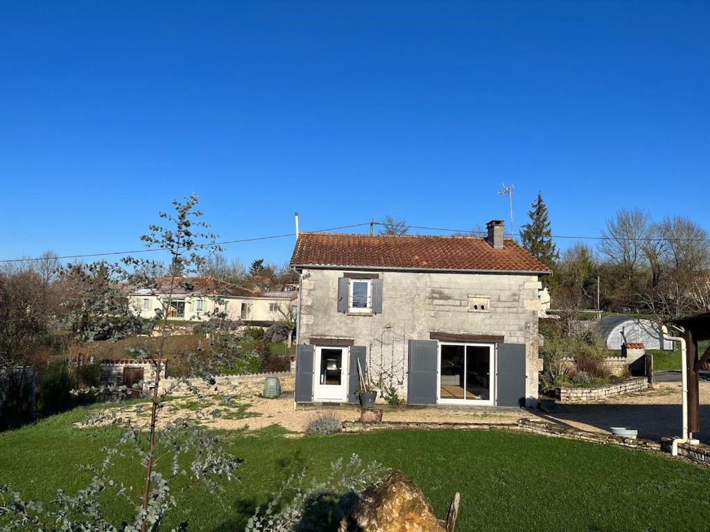 an old stone house with a yard and a garden at Country home in Saint-Ciers-sur-Bonnieure