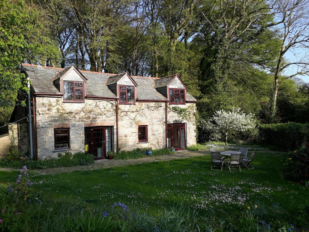 una vecchia casa in pietra in mezzo a un cortile di Pandia Cottage a Bodmin