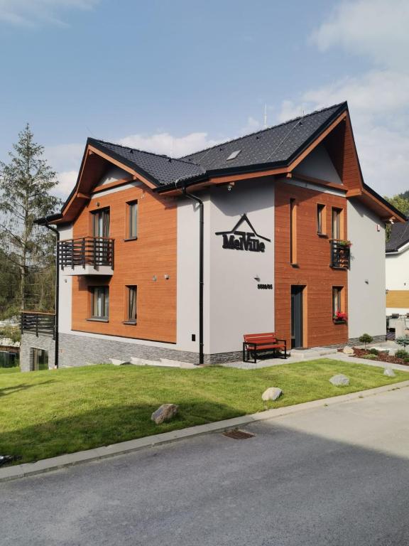 a house with a black roof at MelVille in Ružomberok