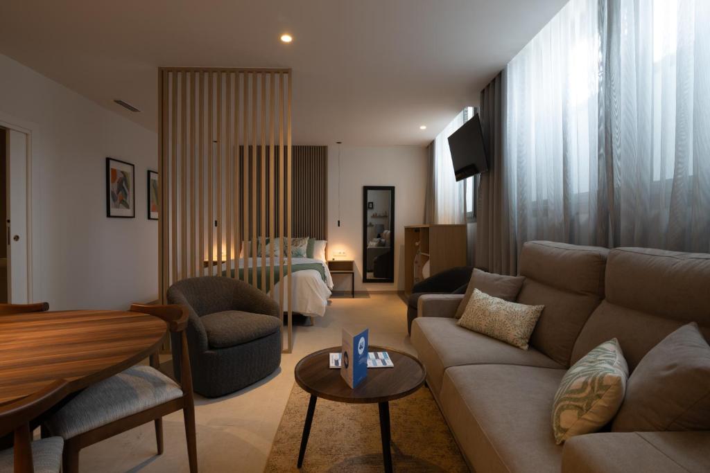 a living room with a couch and a bed at Dorm4You Arena in Valencia